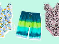 Two one-piece swimsuits and a pair of swim shorts against a green background.