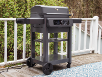 The Current Model G Electric Grill sits on a patio in front of a white railing.