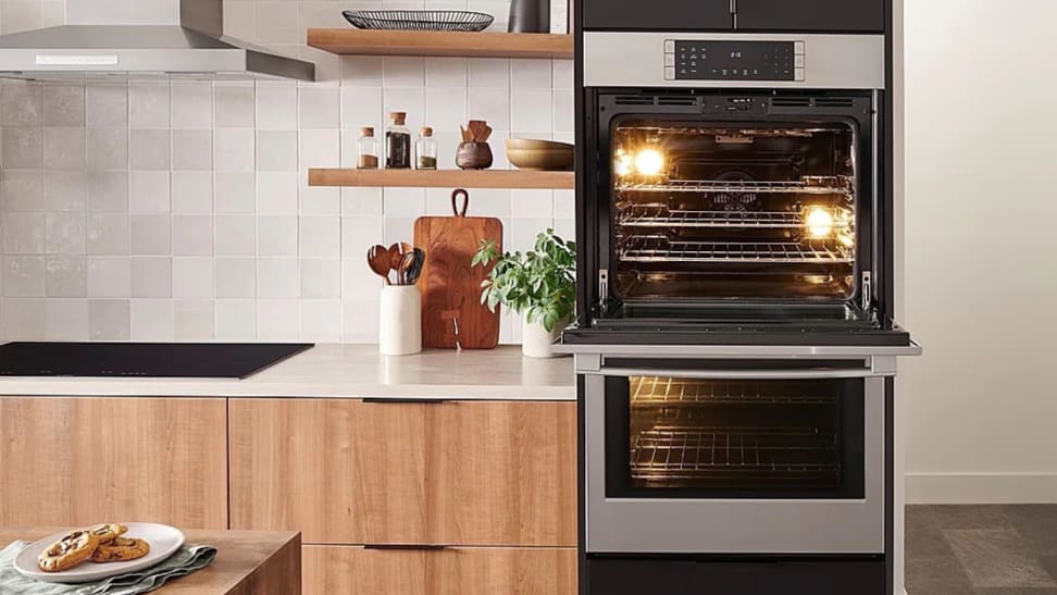 Bosch stacked oven in modern-style kitchen, with top oven open.