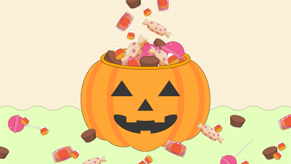 A cartoon jack-o-lantern filled with candy that's spread out all around it.