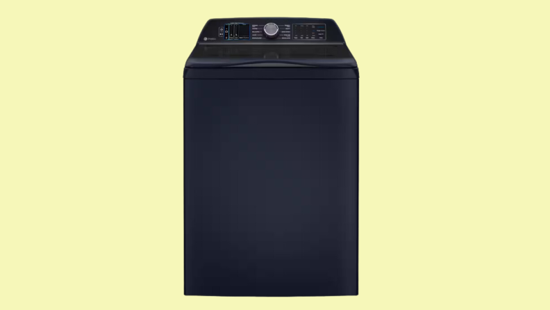 A black top-load washer sits on a yellow background.