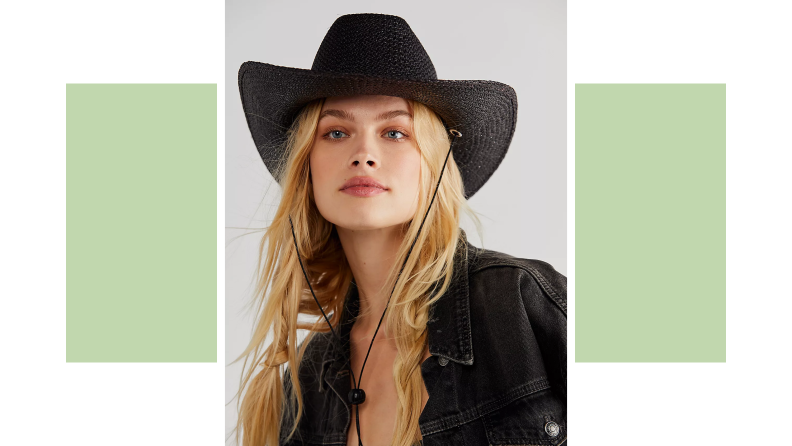 A model wearing a black cowboy hat.