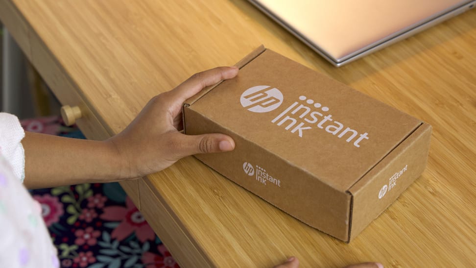 Person holding a box from HP Instant Ink