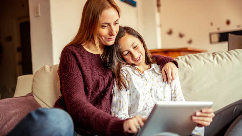 Mother and daughter using a tablet together