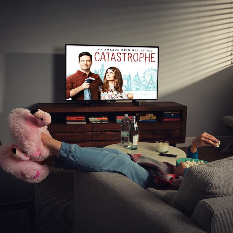 A woman lounging watching Catastrophe on Amazon Fire TV