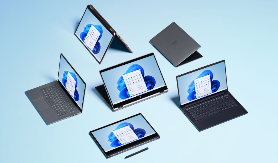 Several laptops sitting next to each other in a group
