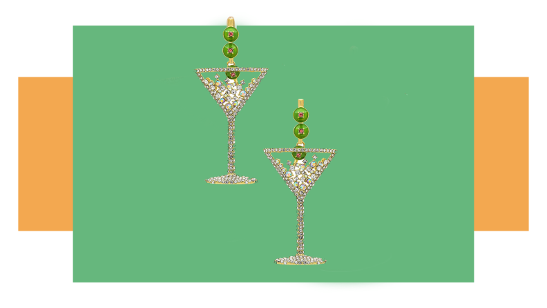 A pair of rhinestone earrings that look like martini glasses with bows on them.