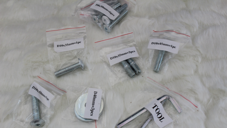Several screws and tools inside of plastic baggies with labels on them.
