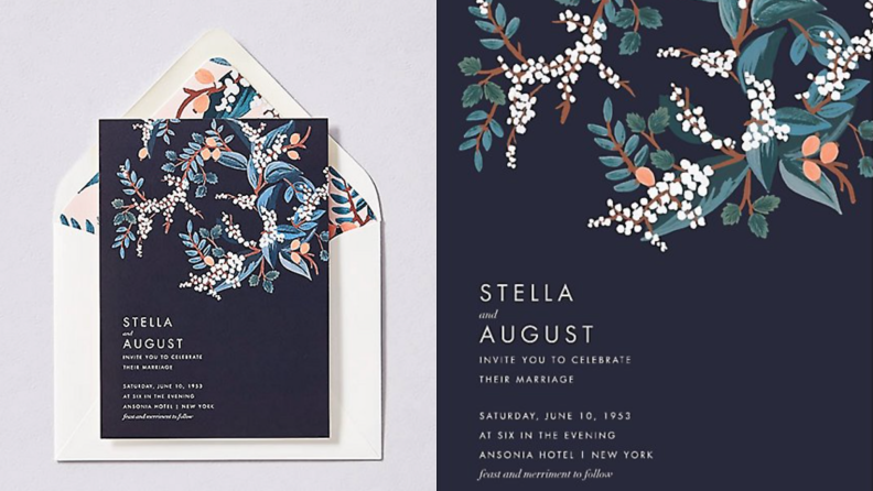 Navy blue wedding invitation with floral pattern at top.