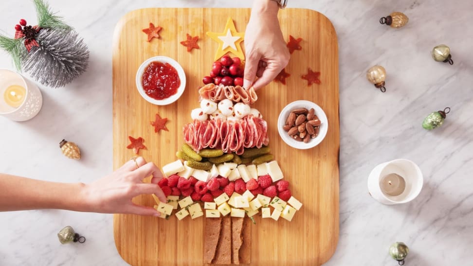 A cutting board with snacks making up a Christmas tree.