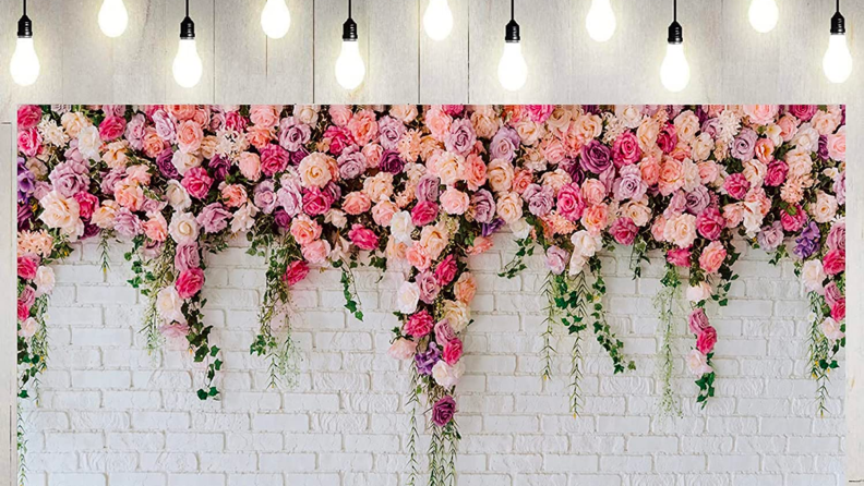 A floral and white brick photo backdrop.