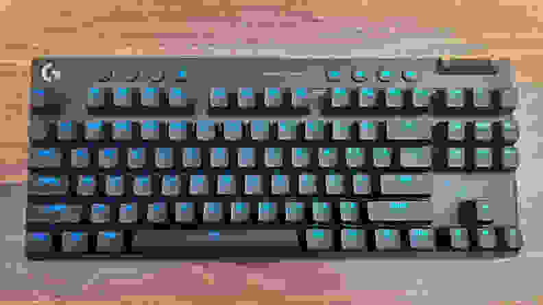 The Logitech G Pro X TKL keyboard on a wood table.