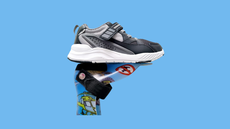 The Stride Rite kids shoe sitting on top of a shoe brace.