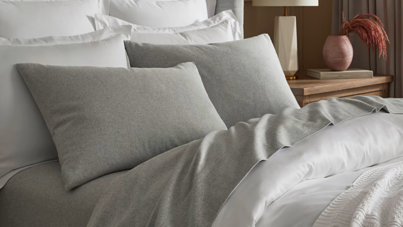 An image of a gray set of Boll and Branch flannel sheets arranged on a bed.