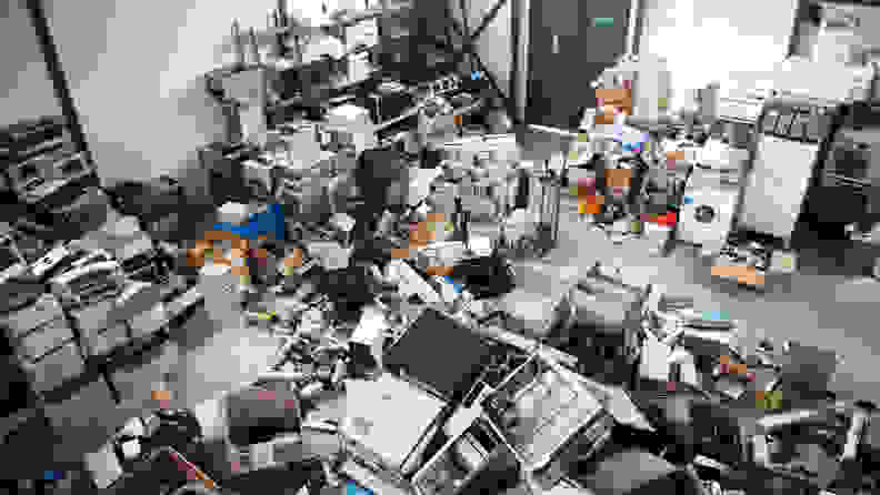 Obsolete computer electronics equipment and appliances are in different piles around a recycling facility.