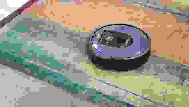 An Roomba vacuum on a rug.