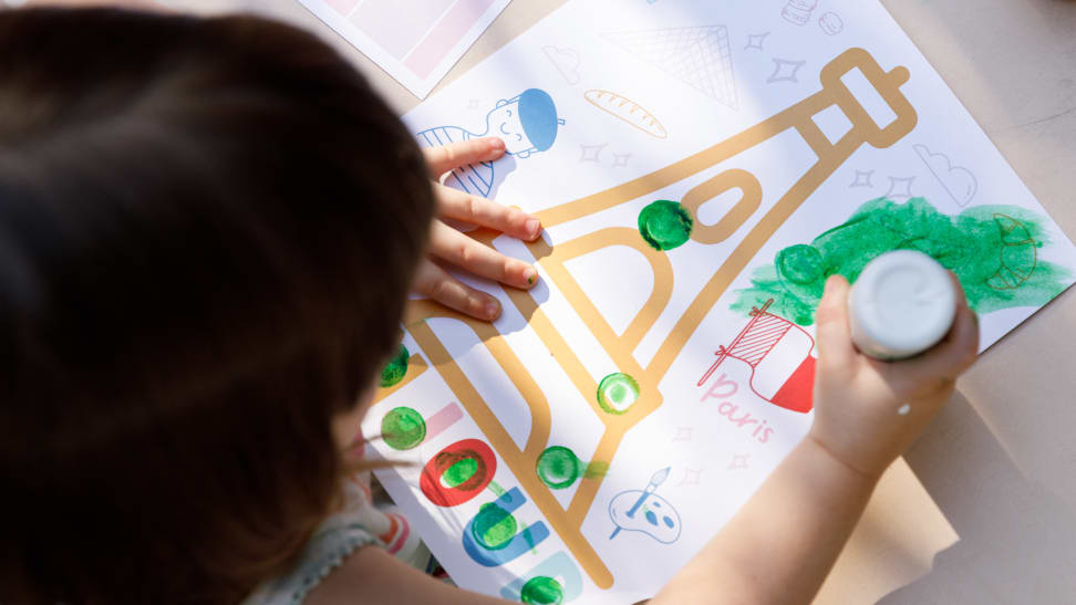 A child painting a picture of the Eiffel Tower