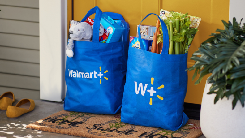 Two reusable Walmart bags with groceries sitting outside a home's door
