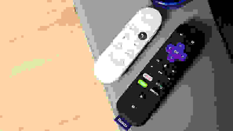 The Google Chromecast with Google TV remote next to the Roku remote