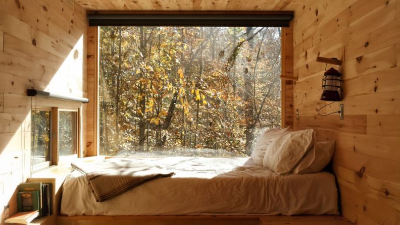 A bed in front of a large window