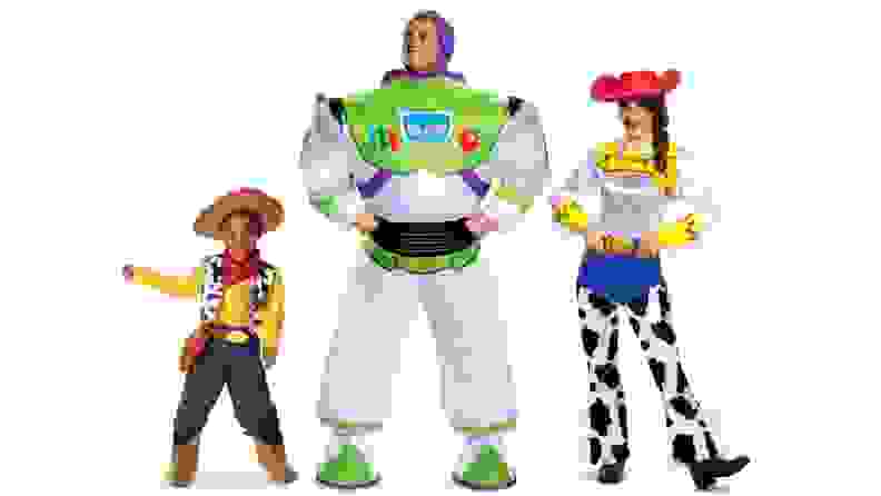 A family in Pixar's Toy Story costumes: Woody, Buzz, and Jessie.