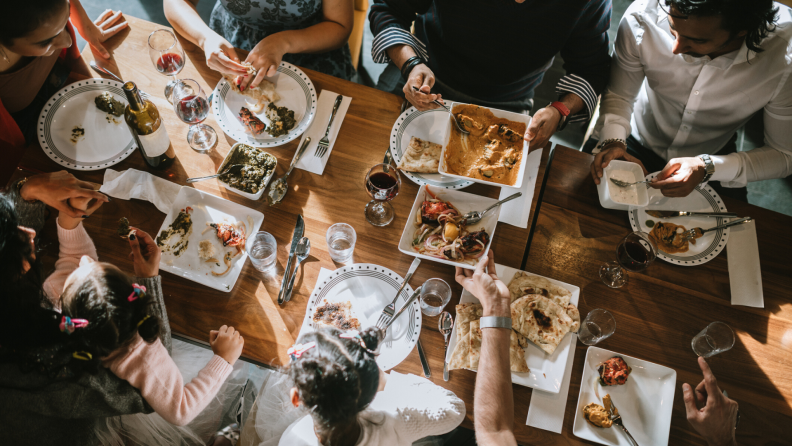 Family enjoying a meal around a table