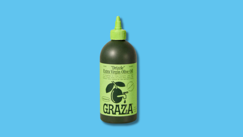 Single green squeeze bottle of Gaza olive oil in front of blue background.