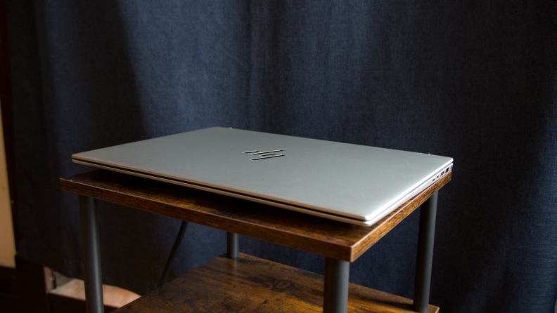 The laptop closed atop a stool.