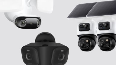 Three large sized security cameras on a gray background