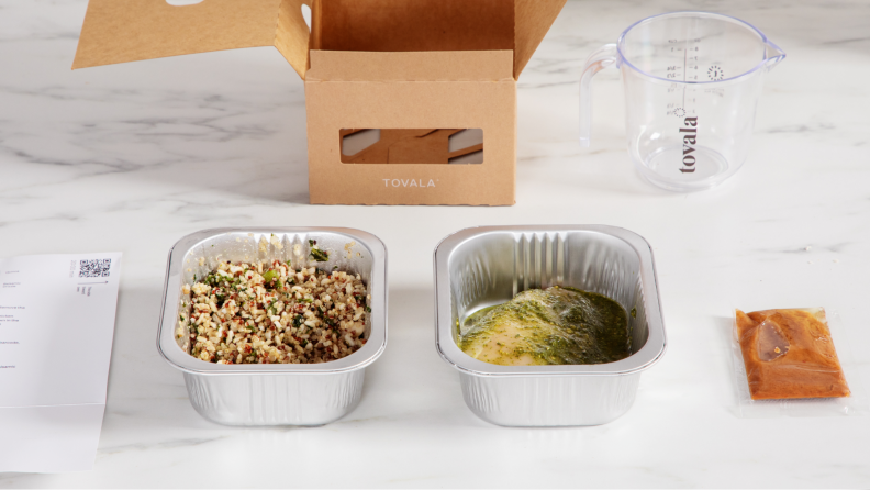 A prepared Tovala meal in two rectangular tins on a white counter.
