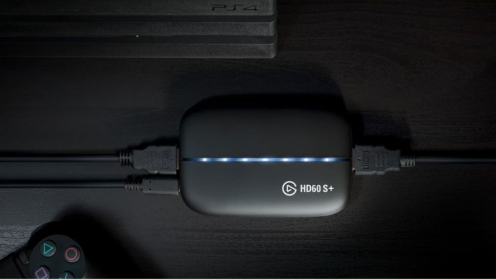 An image of an Elgato HD60 S+ capture card next to a PlayStation controller.