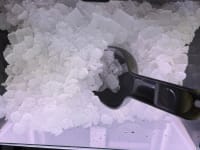 Close up photo of ice with scooper.