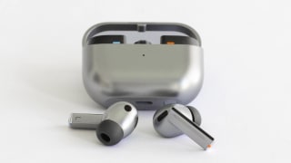 The Samsung Galaxy Buds3 Pro earbuds in front of its charging case.