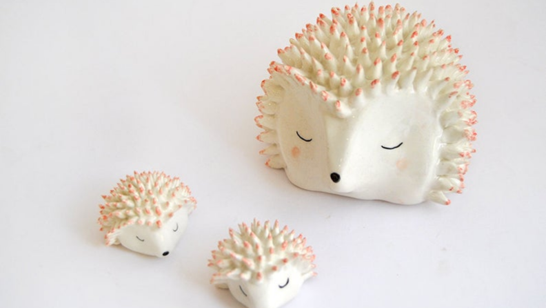 An image of three adorable ceramic hedgehogs.