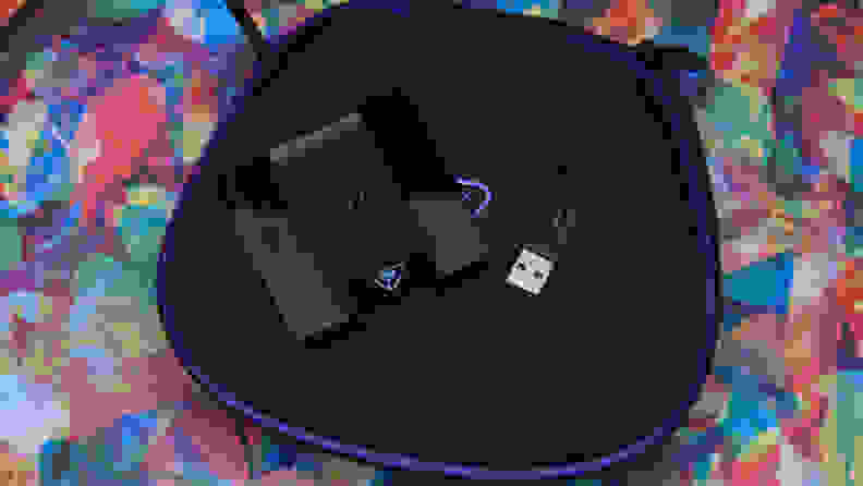 The charging station and the USB dongle laying down flat.