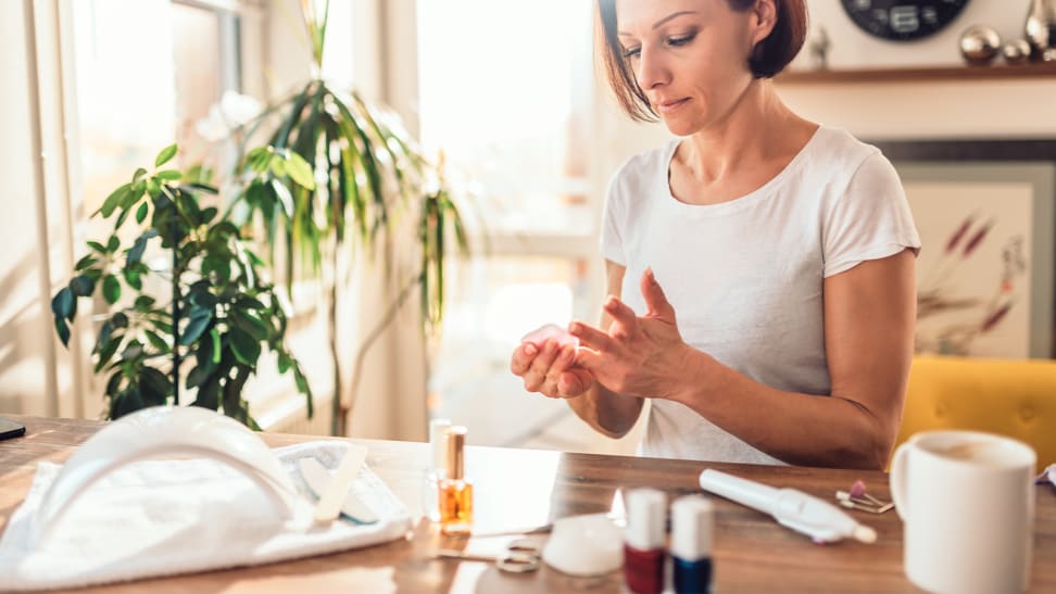 A photo of a woman giving herself a manicure.