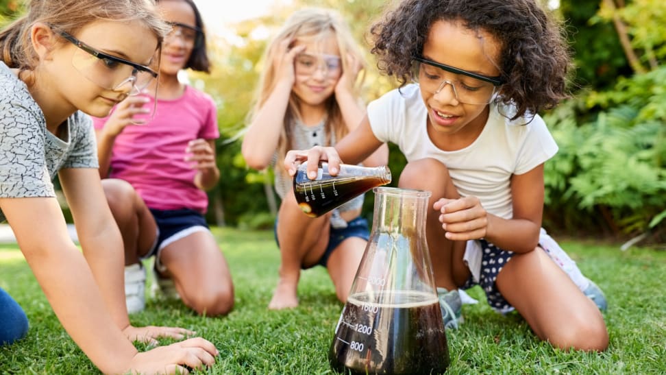 Girls conducting a science experiment in their backyard