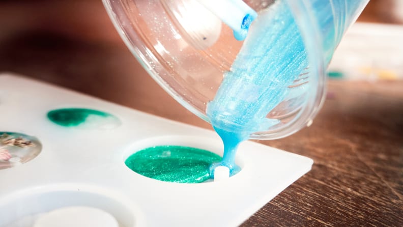 resin being poured into mold from a plastic cup