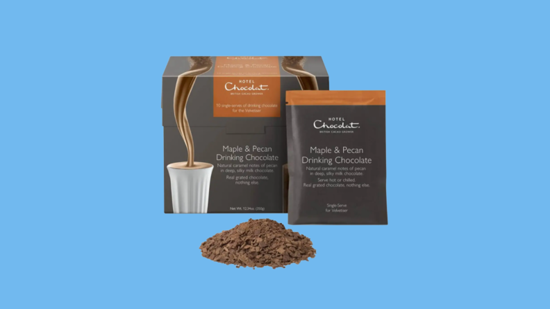 Hot chocolate bag, package and grounds against blue background