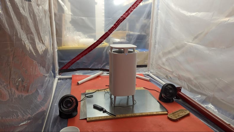 A white standing air purifier in a controlled laboratory setting.