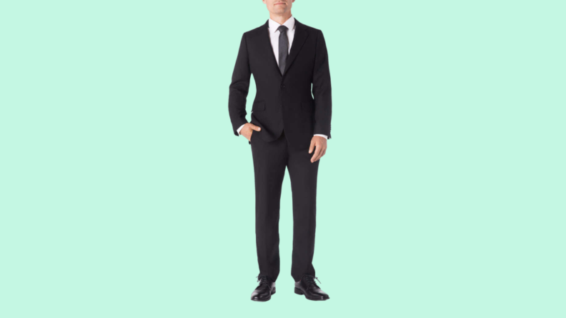 A black suit againt a teal background.