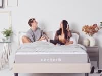 Couple sitting on a Nectar mattress