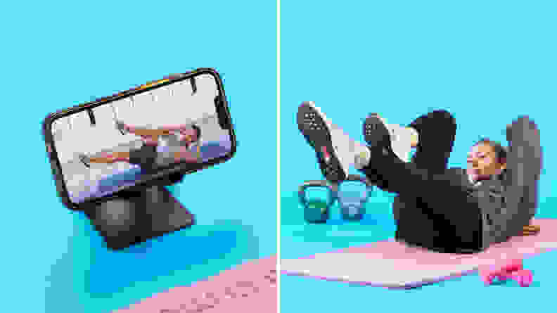 On left, smart phone perched on phone stand with FitOn app on screen. On right, Person laying on yoga mat with feet elevated in the air and arms behind head completing a workout.