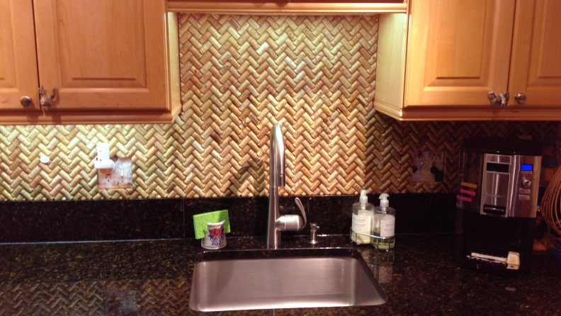 Cork backsplash in kitchen behind sink.