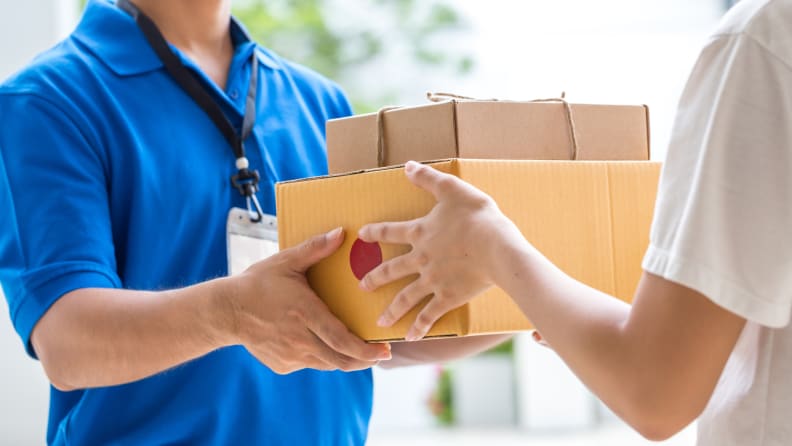 Woman giving packages to man in blue shirt