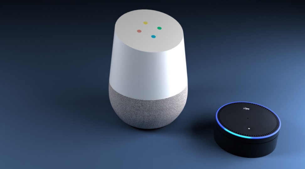 A Google Home speaker sits next to Amazon's Echo Dot speaker.
