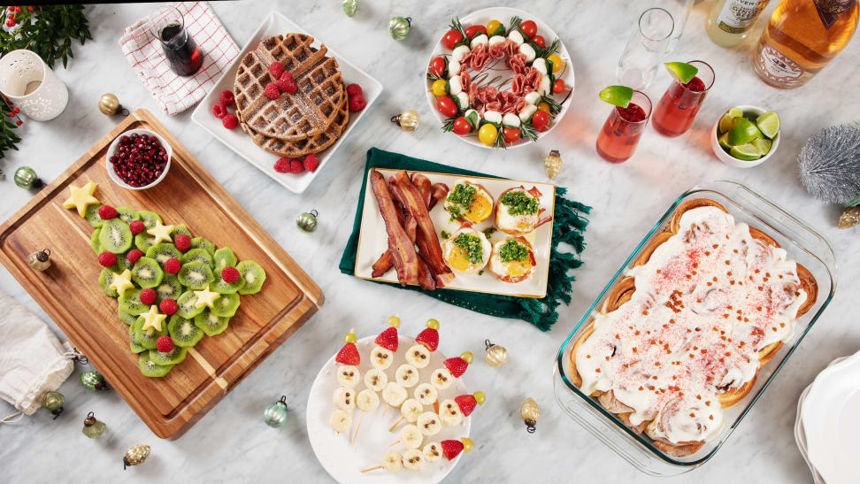 Spread of holiday-themed fruit and brunch items on a marble surface