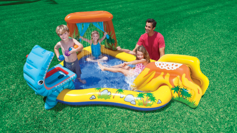 Kids playing in a dinosaur-themed pool