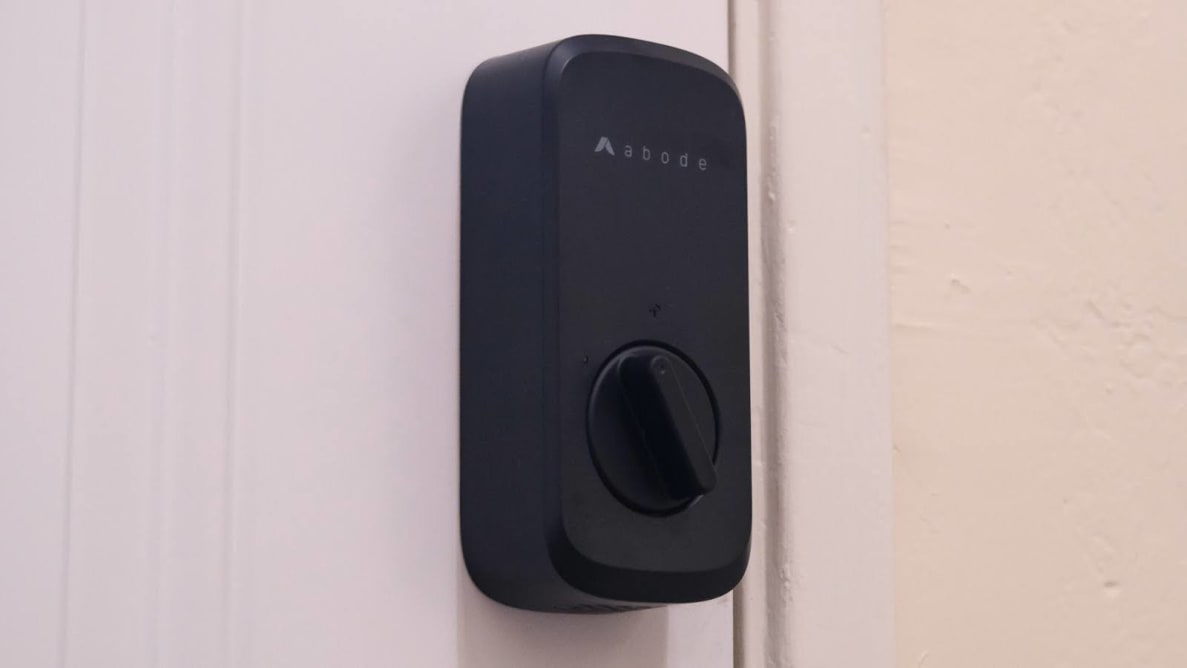 The Abode Lock mounted on white door.