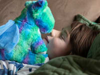 A child goes nose-to-nose with a dragon Warmie